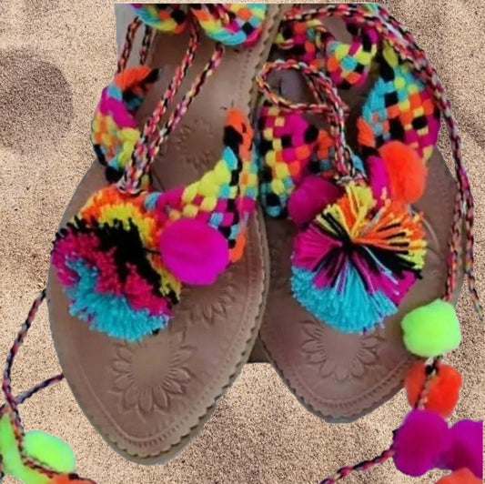 Leather sandals and brightly colored pompoms