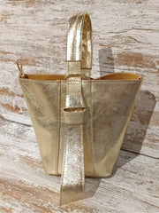 Gold bucket bag. Also in Red. With interior toiletry bag