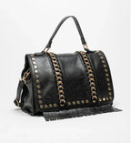 Black bag decorated with gold chains and fringes