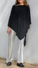 Fine knit cape or poncho. Available in various colors. Novelty