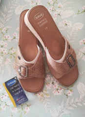 Leather sandals and brightly colored pompoms