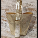 Gold bucket bag. Also in Red. With interior toiletry bag