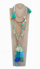 Long necklace with pompoms in aqua green and blue tones