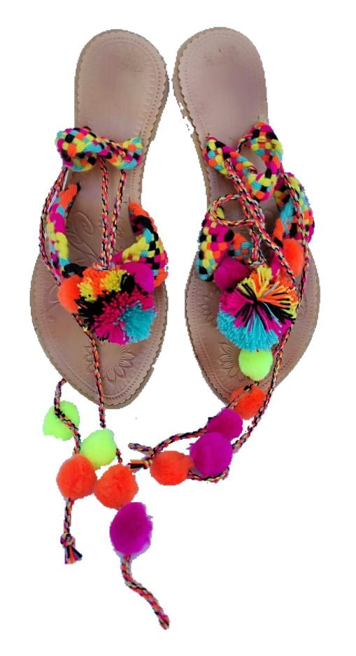 Leather sandals and brightly colored pompoms