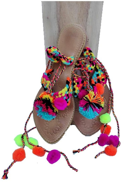 Leather sandals and brightly colored pompoms